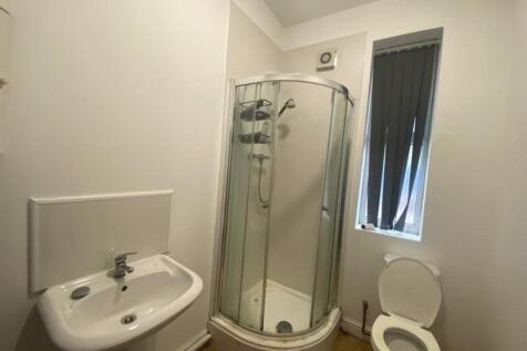 A tidy and modern bathroom featuring a sleek sh...