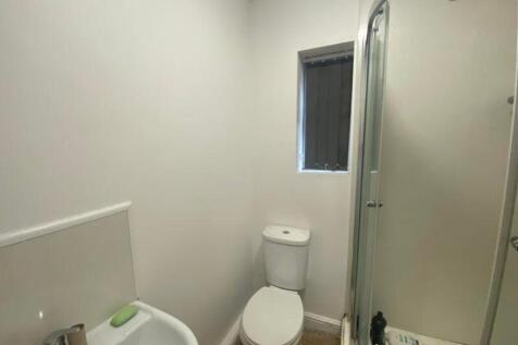A clean and functional bathroom featuring a sho...