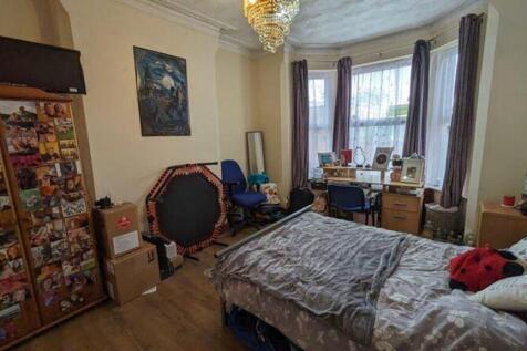 A spacious and well-lit double bedroom, perfect...