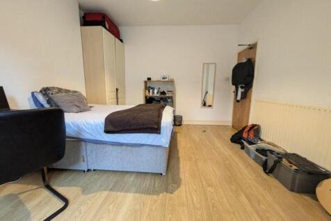 A spacious and inviting double bedroom with nat...