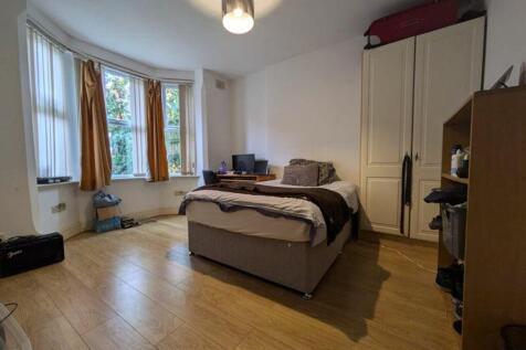 A bright and spacious double bedroom with ample...