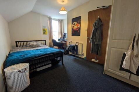 A spacious and well-lit double bedroom perfect ...