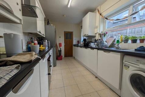 A spacious and bright kitchen equipped with mod...