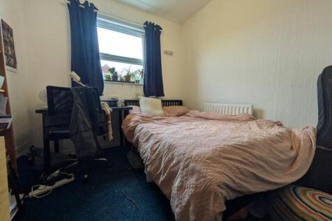 A cozy double bedroom with a comfortable bed an...