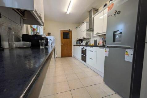 A spacious and bright kitchen equipped with mod...