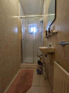 A well-maintained bathroom featuring a shower a...
