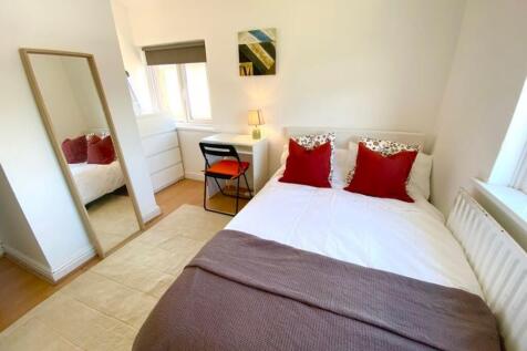 A bright and inviting double bedroom featuring ...