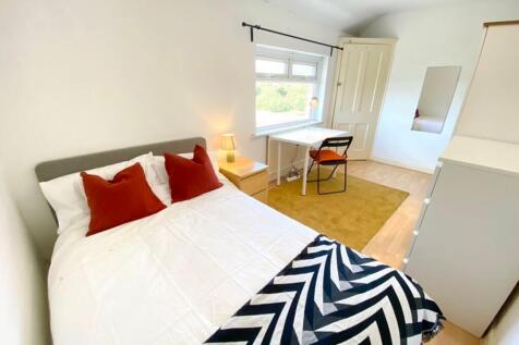 A bright and inviting double bedroom featuring ...