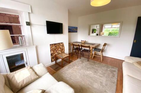 A bright and inviting living room with a cozy a...