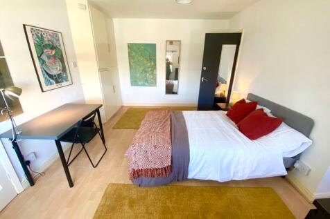 A bright and spacious double bedroom featuring ...