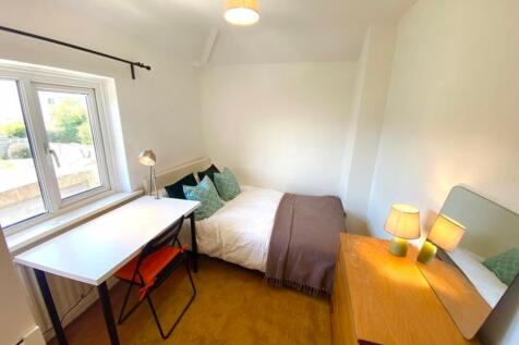 A bright and inviting double bedroom featuring ...