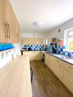 A bright and modern kitchenette featuring ample...