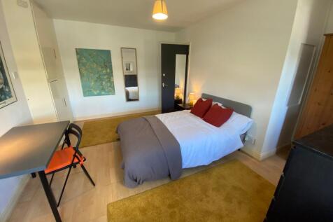 A bright and inviting double bedroom featuring ...