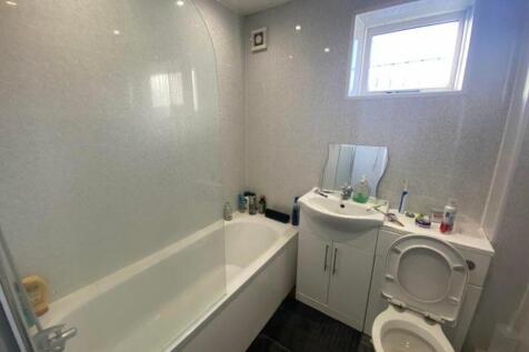 A modern and clean bathroom featuring a bath an...