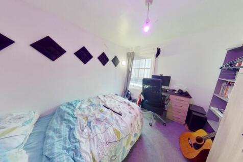 A bright and inviting double bedroom with a coz...