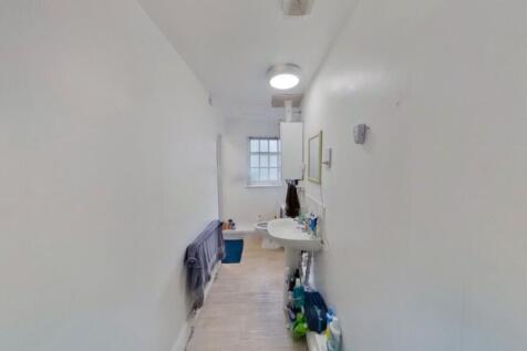 A bright and tidy bathroom with essential ameni...