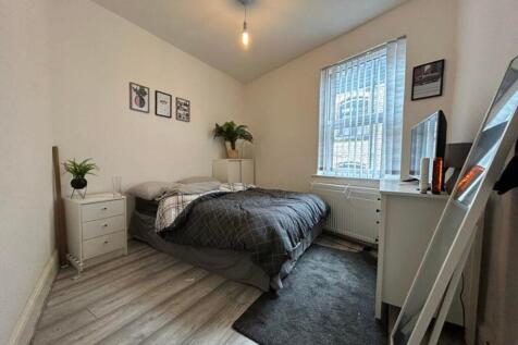 A bright and tidy double bedroom featuring styl...