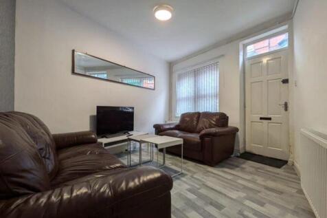 A bright and inviting living room featuring com...