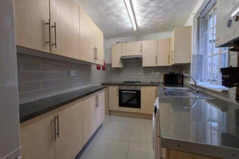 A bright and tidy kitchen featuring modern cabi...