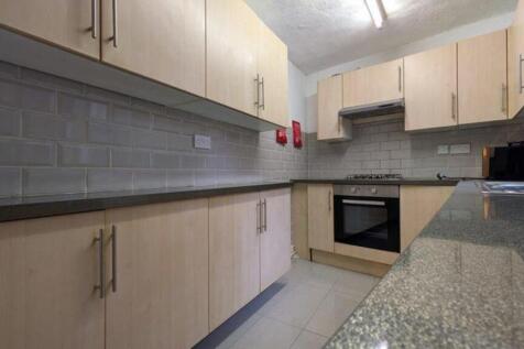 A modern and tidy kitchenette with ample storag...