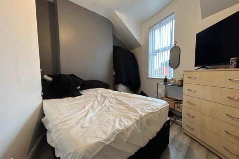 A cozy double bedroom featuring ample natural l...