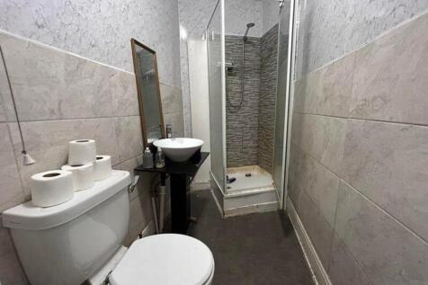 A tidy and functional bathroom featuring a show...