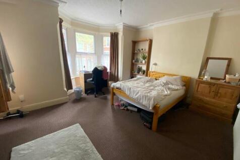 A spacious and inviting double bedroom filled w...
