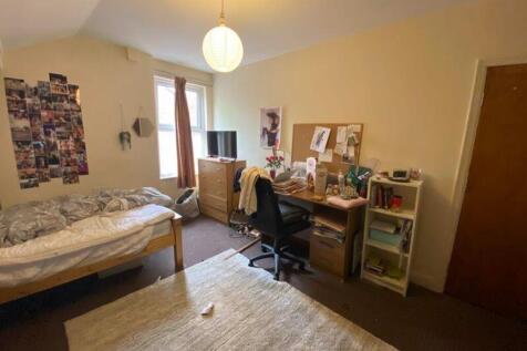 A spacious and inviting double bedroom with goo...