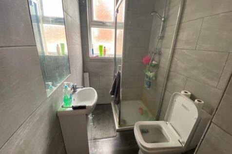 A modern and tidy bathroom featuring a shower a...
