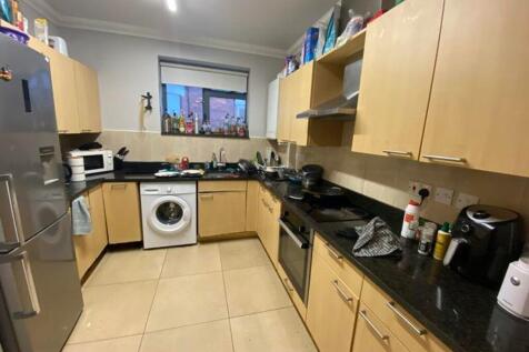 A spacious kitchen equipped with modern applian...