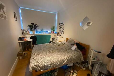 A spacious double bedroom with good natural lig...