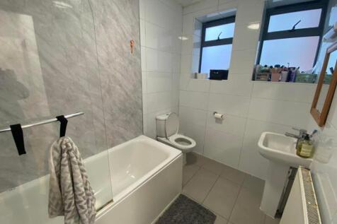 A modern and clean bathroom featuring a bath an...