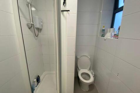 A clean and functional bathroom featuring a sho...