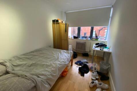 A spacious double bedroom with plenty of natura...