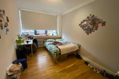 A bright and inviting double bedroom with a coz...