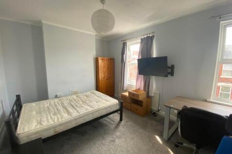 A spacious and well-lit double bedroom featurin...