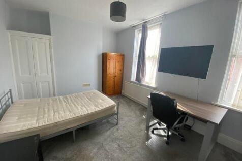 A spacious and bright double bedroom featuring ...