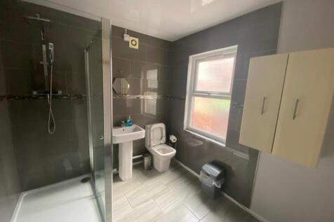 A modern and tidy bathroom featuring a spacious...