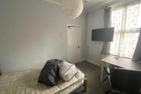 A cozy and well-lit double bedroom with a comfo...