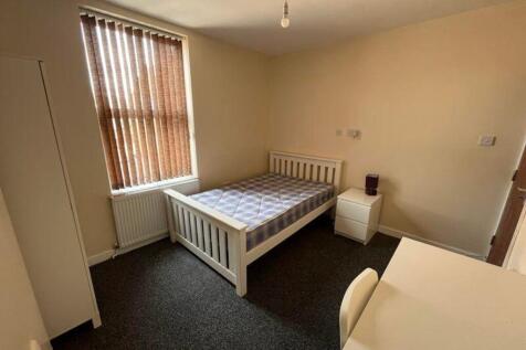 A bright and inviting double bedroom featuring ...