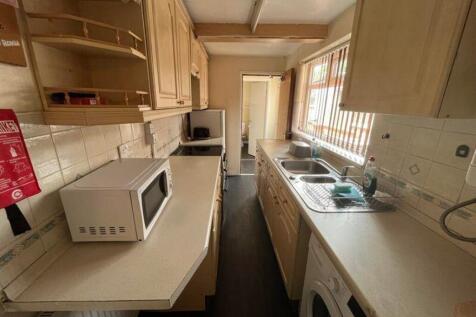 A tidy and functional kitchenette with ample st...