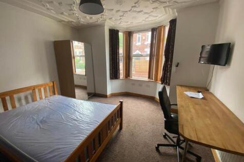 A spacious and well-lit double bedroom featurin...