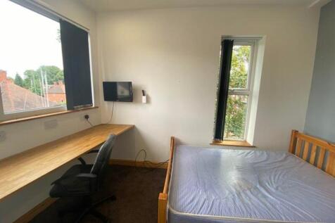 A bright and inviting double bedroom featuring ...
