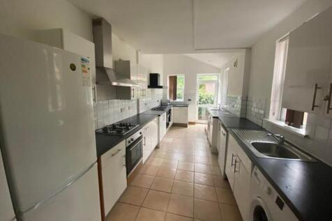 A spacious and bright kitchen equipped with mod...