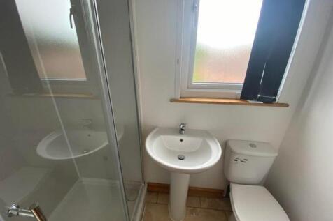 A bright and tidy bathroom featuring a modern s...