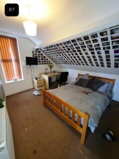 A cozy double bedroom with a creative wall of p...