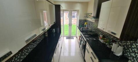 A modern and stylish kitchenette featuring slee...