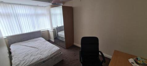 A spacious and well-lit double bedroom featurin...