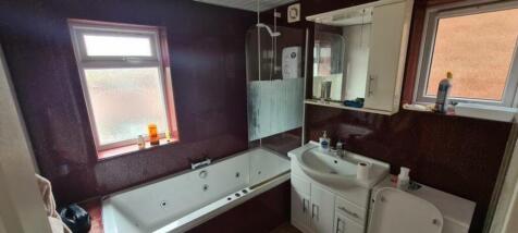 A spacious and modern bathroom featuring a luxu...
