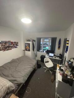 A cozy double bedroom with a workspace and ampl...